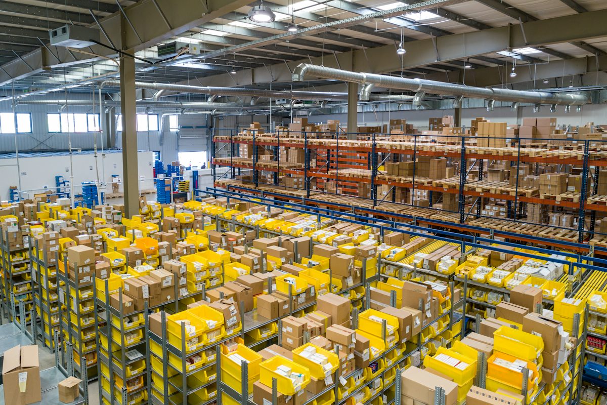 Distribution warehouse with rows of stocked shelving